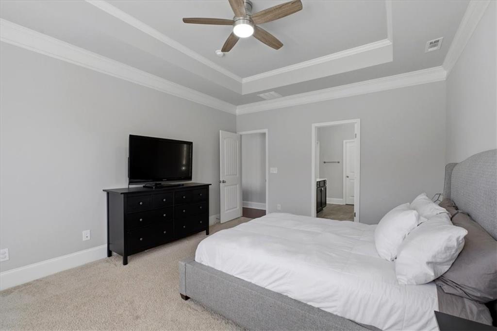 621 Little Bear Loop Canton, GA 30114 - Photo 21 of 45 a bedroom with a bed and a flat screen tv