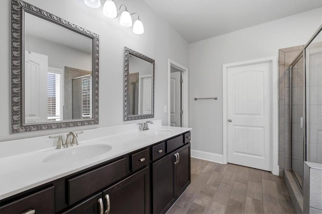 621 Little Bear Loop Canton, GA 30114 - Photo 22 of 45 a bathroom with a sink double vanity and a mirror
