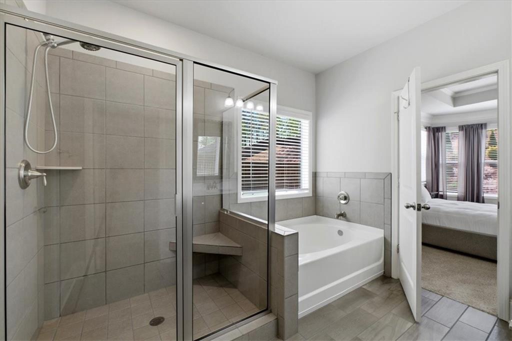 621 Little Bear Loop Canton, GA 30114 - Photo 23 of 45 a bathroom with a bathtub and a shower