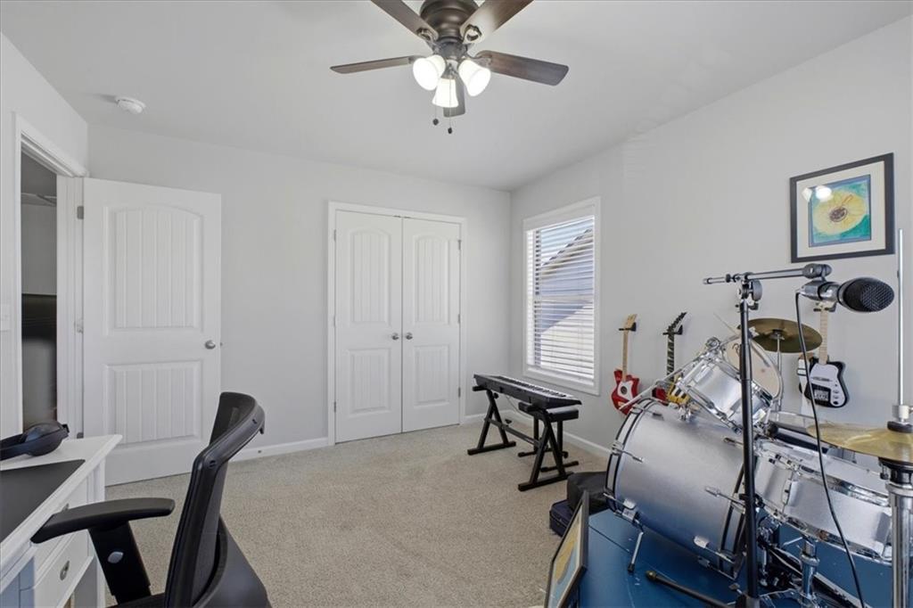 621 Little Bear Loop Canton, GA 30114 - Photo 27 of 45 a workspace with chandelier fan and a window