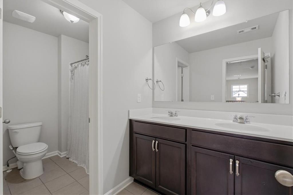 621 Little Bear Loop Canton, GA 30114 - Photo 30 of 45 a bathroom with a toilet a sink and mirror