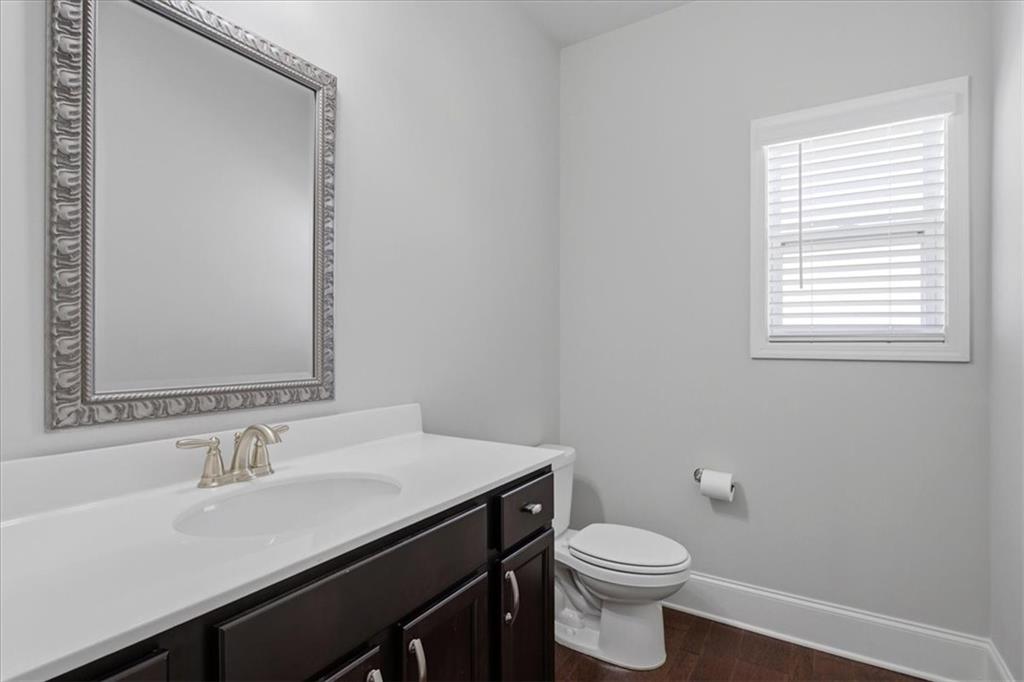 621 Little Bear Loop Canton, GA 30114 - Photo 10 of 45 a bathroom with a sink a toilet and a mirror