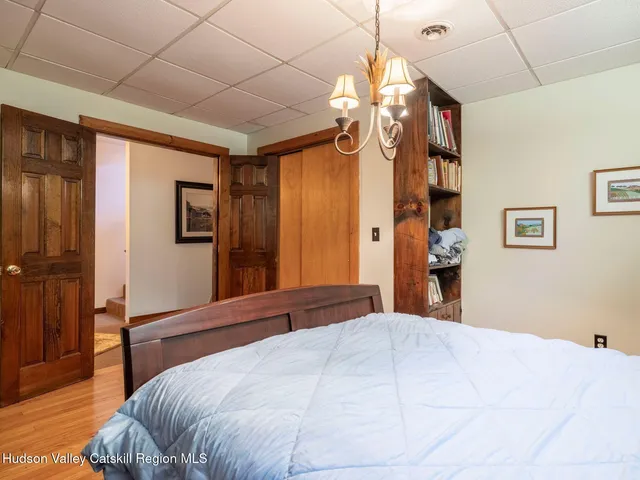 a bedroom with a large bed and a chandelier