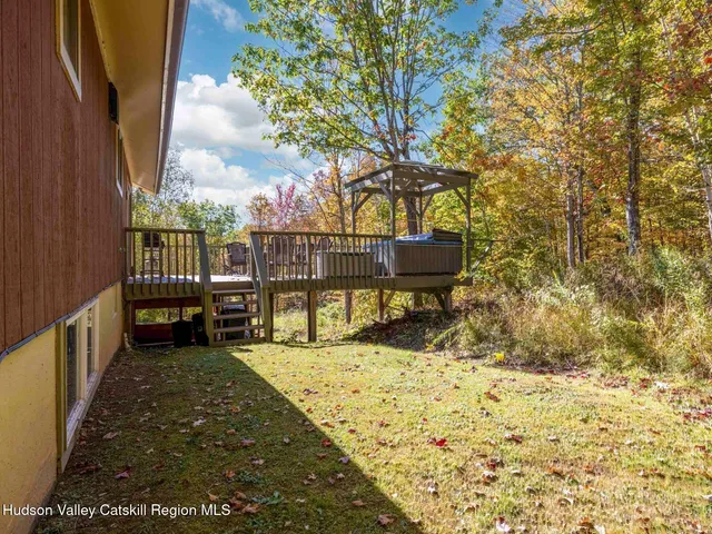 a view of roof deck with wooden fence and floor