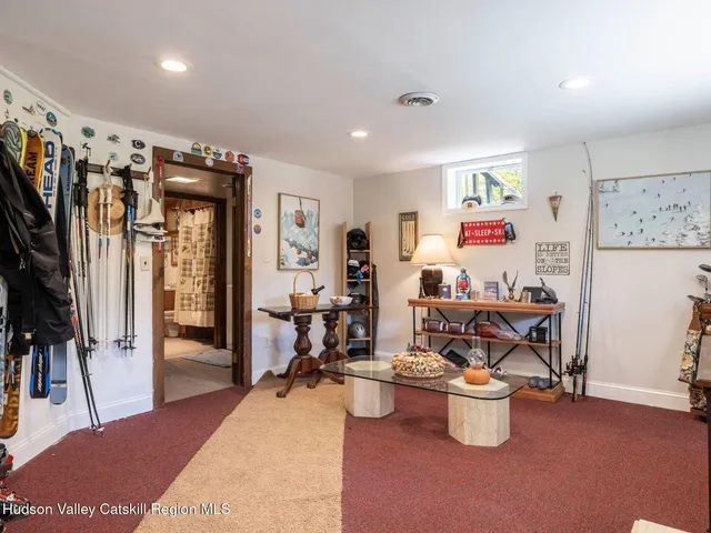 a living room with furniture a window and a flat screen tv