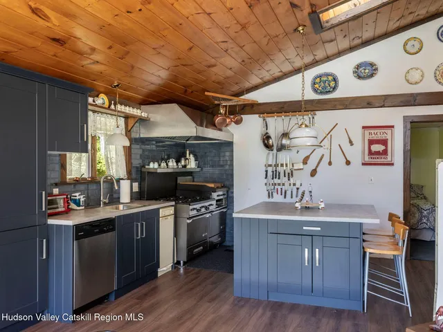 a kitchen with stainless steel appliances granite countertop a sink stove and wooden cabinets