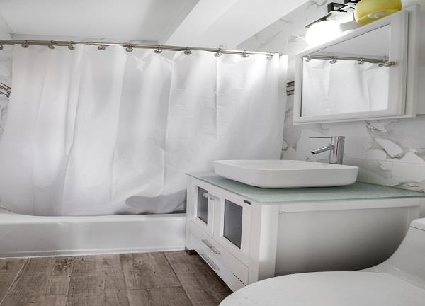 141-25 78th Avenue, Unit 3B Queens, NY 11367 - Photo 6 of 7 a bathroom with a sink and a mirror