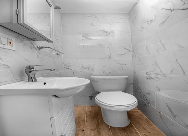 141-25 78th Avenue, Unit 3B Queens, NY 11367 - Photo 7 of 7 a bathroom with a sink toilet and a mirror