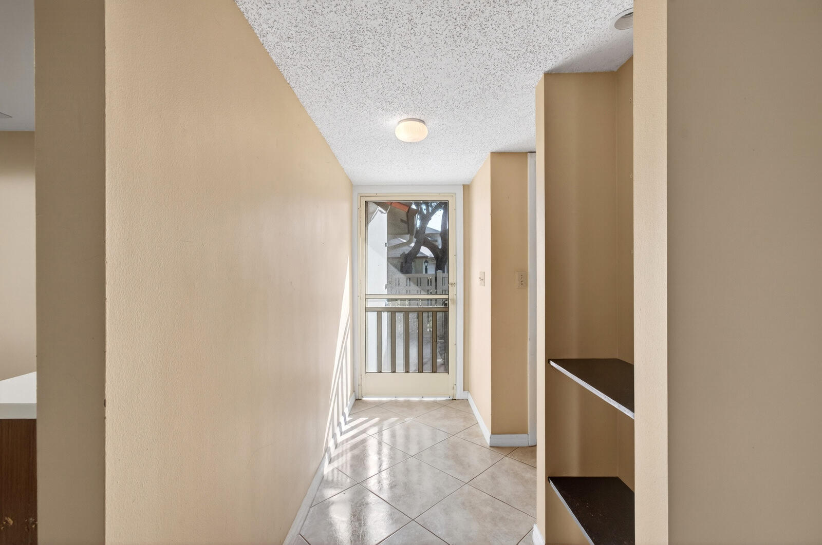 3951 Northeast 19th Road, Unit 1701 Pompano Beach, FL 33064 - Photo 17 of 82 a view of a hallway with wooden shelves