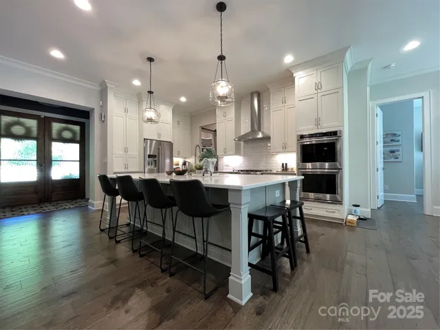 a kitchen with a dining table chairs and view kitchen