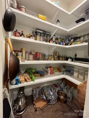 a kitchen with lots of clutter and cabinets