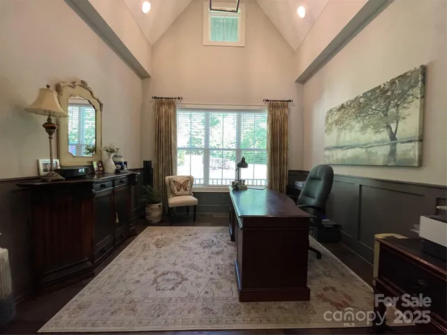 a view of a workspace with furniture and a window