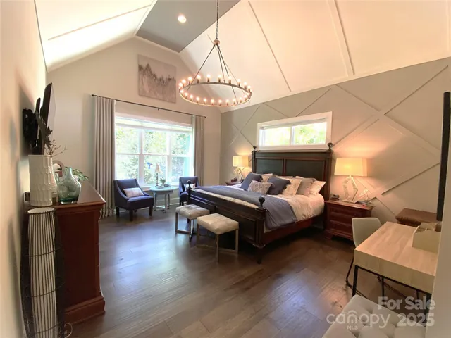 a spacious bedroom with bed and a chair