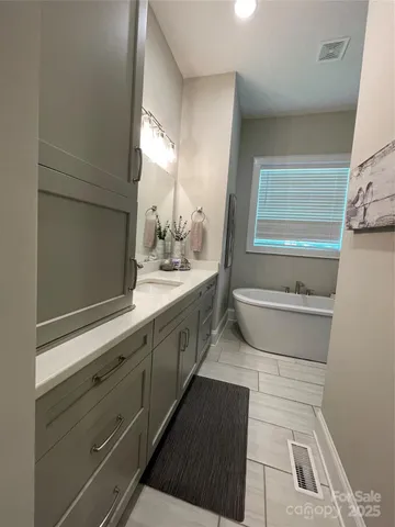 a bathroom with a double vanity sink a mirror and a toilet