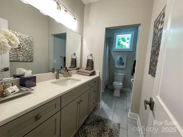 a bathroom with a double vanity sink and a mirror