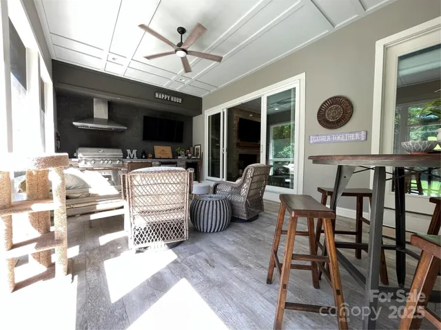 a bedroom with furniture and a large window