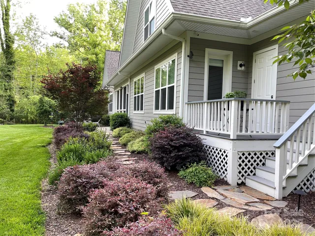 a view of a house with a yard and plants