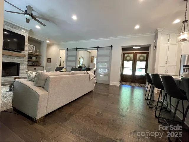 a living room with fireplace furniture and a wooden floor