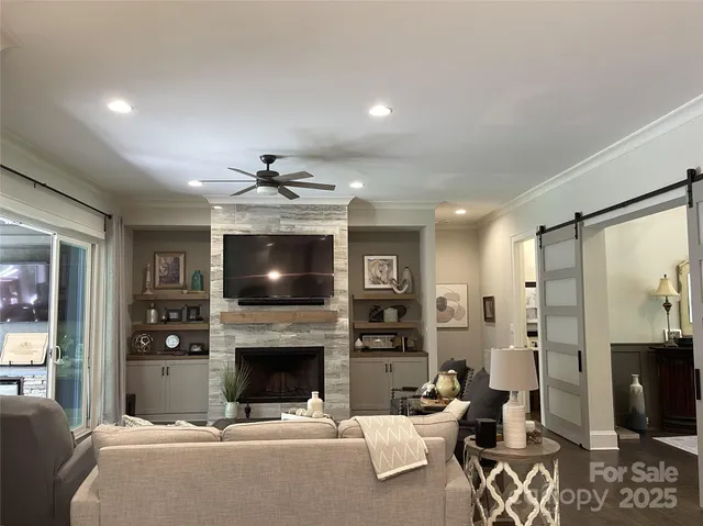 a living room with furniture a flat screen tv and a fireplace
