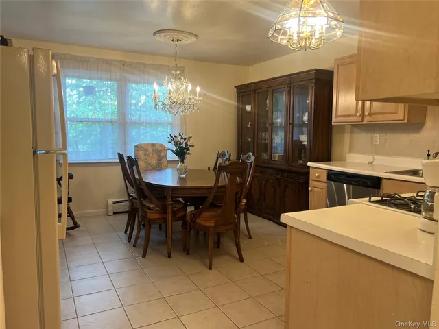 a dining room with furniture a chandelier and window