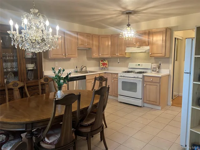 a kitchen with cabinets and chairs