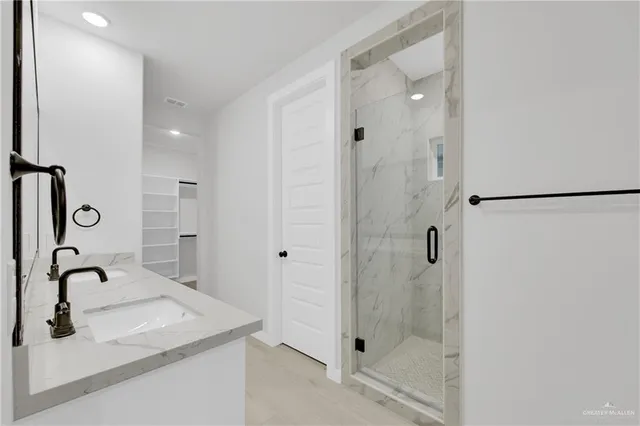 a view of a big room with a ceiling fan and closet area