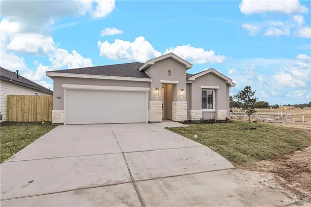 a view of an house with backyard and ocean