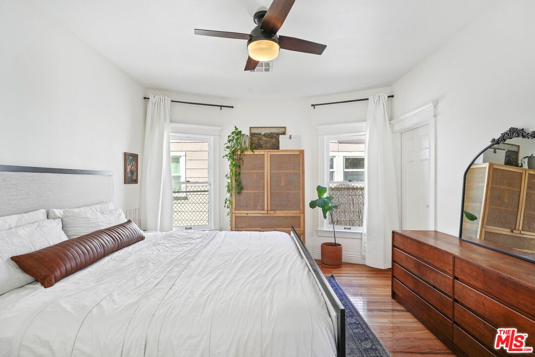 5159 Meridian Street Los Angeles, CA 90042 - Photo 12 of 41 a bedroom with a large bed and ceiling fan