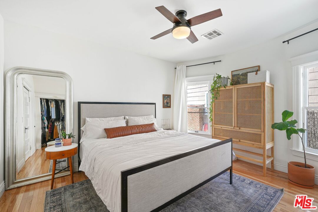 5159 Meridian Street Los Angeles, CA 90042 - Photo 13 of 41 a bedroom with a large bed and a chandelier
