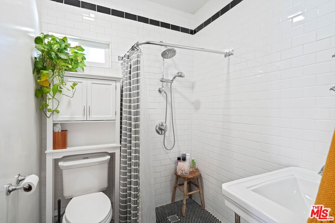 5159 Meridian Street Los Angeles, CA 90042 - Photo 18 of 41 a bathroom with a toilet and a shower