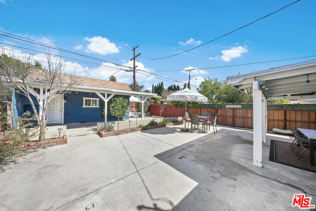 5159 Meridian Street Los Angeles, CA 90042 - Photo 25 of 41 a view of a patio with a table and chairs under an umbrella