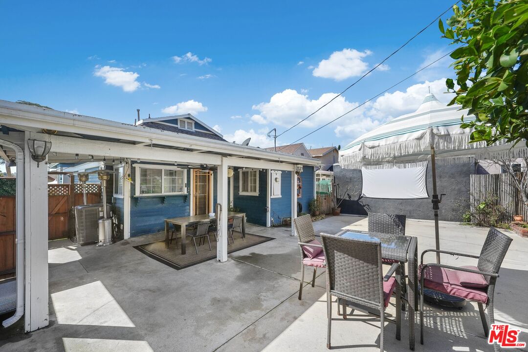 5159 Meridian Street Los Angeles, CA 90042 - Photo 28 of 41 a view of a patio with dining table and chairs with a small yard
