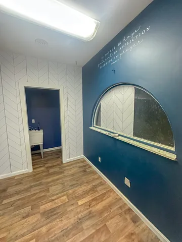 a view of a room with a dishwasher and a dresser