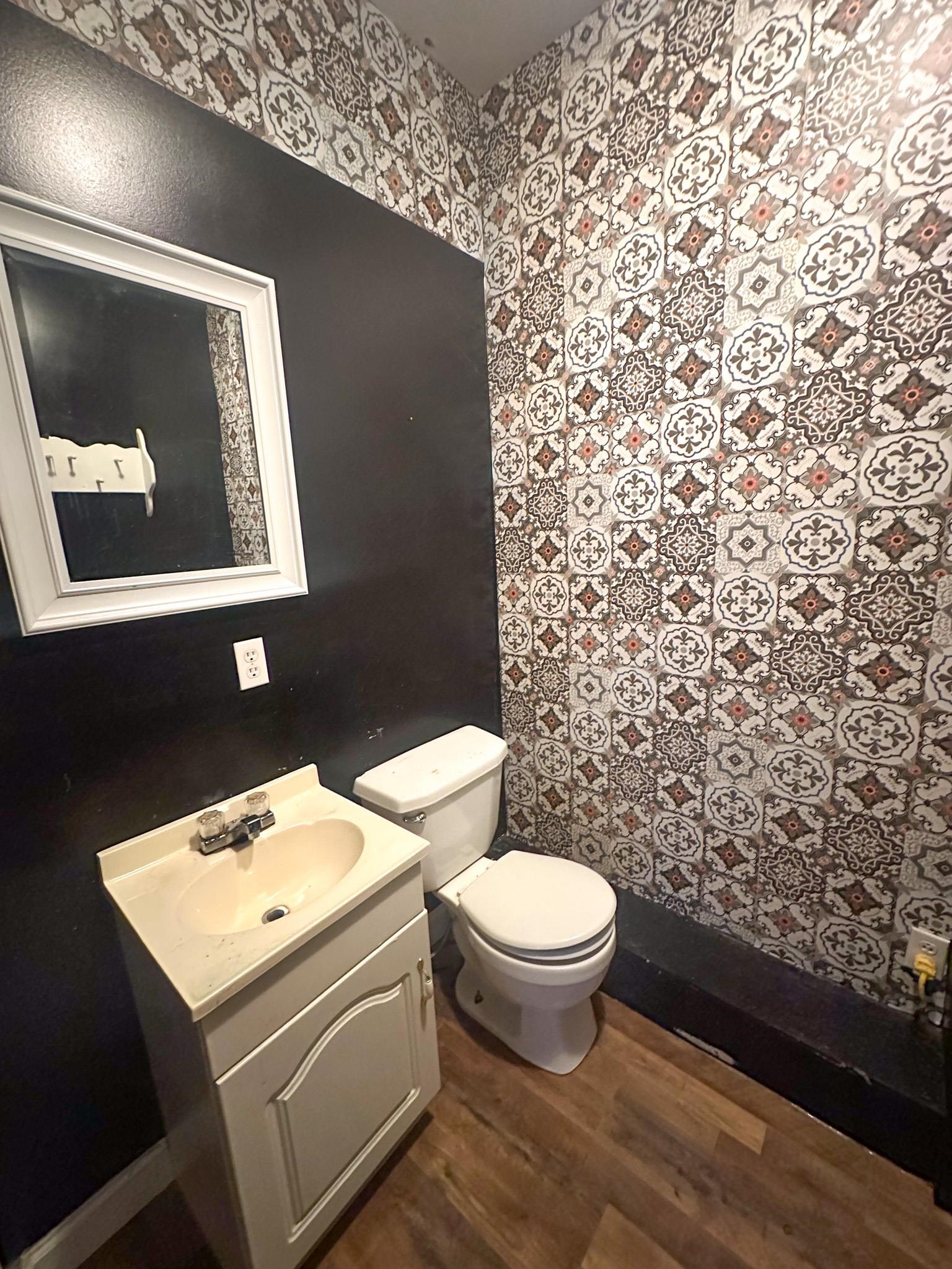 800 East Quitman Street Iuka, MS 38852 - Photo 6 of 7 a bathroom with a toilet sink and mirror