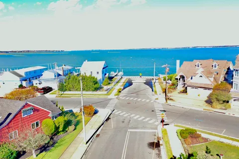 swimming pool view with a couple of cars parked