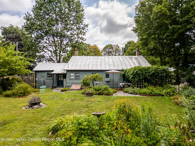 a view of a house with pool and garden