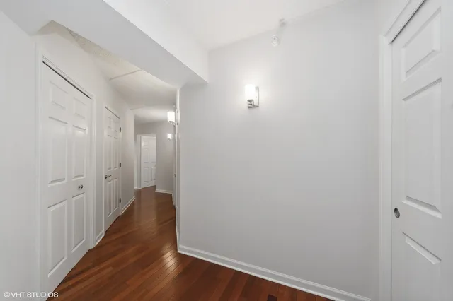 a view of a hallway with wooden floor