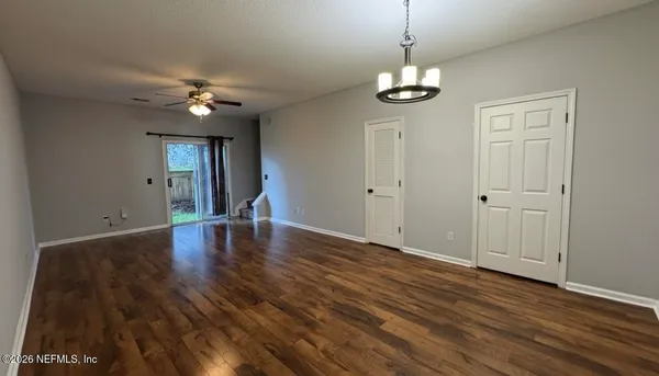 a view of entryway and hall with wooden floor