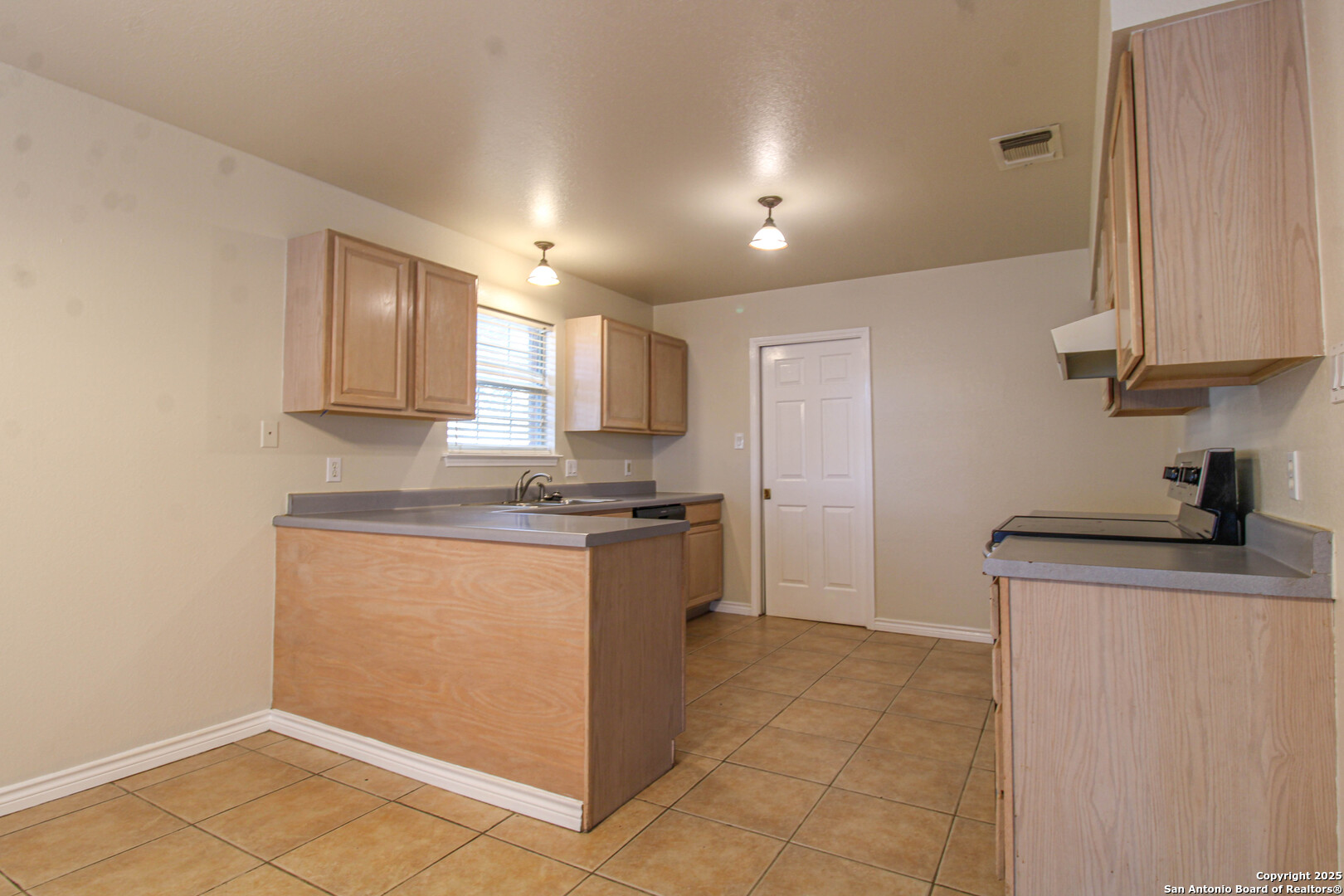 6703 Ridge Pl Street San Antonio, TX 78250 - Photo 14 of 44 a kitchen with stainless steel appliances granite countertop a stove a sink and a refrigerator