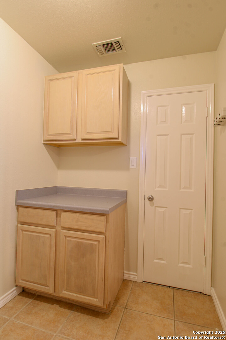 6703 Ridge Pl Street San Antonio, TX 78250 - Photo 18 of 44 a view of cabinets and window