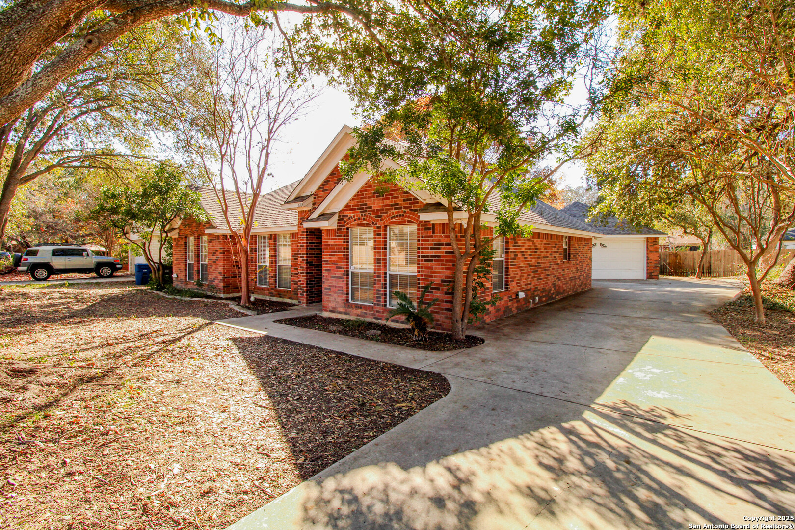 6703 Ridge Pl Street San Antonio, TX 78250 - Photo 2 of 44 a view of a large white house with a large tree in front of it