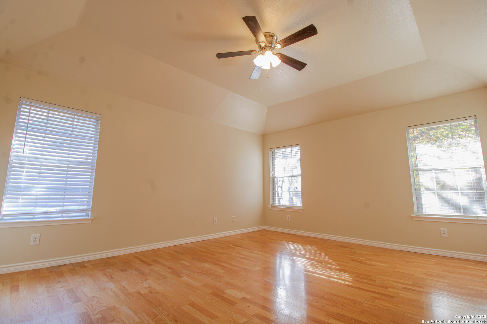 6703 Ridge Pl Street San Antonio, TX 78250 - Photo 21 of 44 a view of an empty room with a window and wooden floor