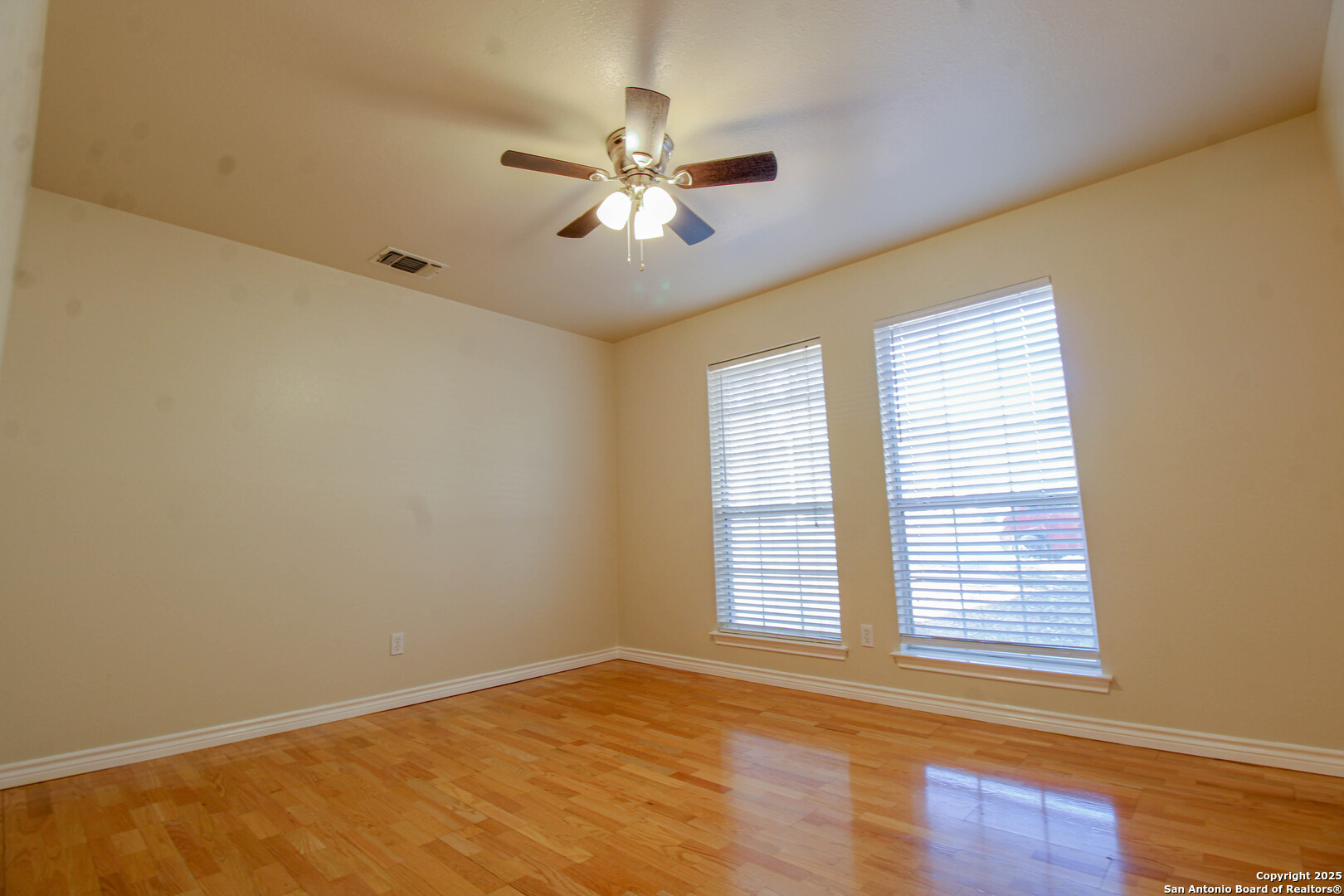 6703 Ridge Pl Street San Antonio, TX 78250 - Photo 28 of 44 a view of an empty room with wooden floor and a window