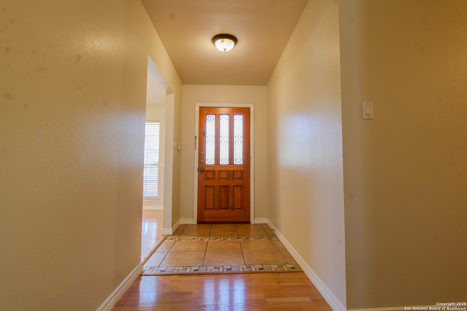 6703 Ridge Pl Street San Antonio, TX 78250 - Photo 4 of 44 a view of a hallway with wooden floor and a bathroom