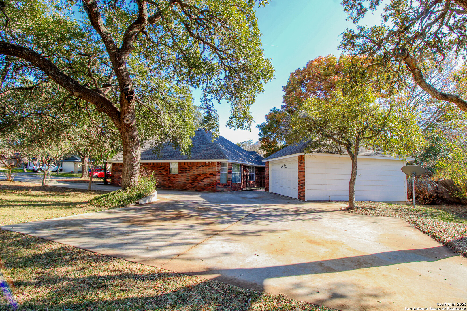 6703 Ridge Pl Street San Antonio, TX 78250 - Photo 41 of 44 a view of large house with a big yard and large trees