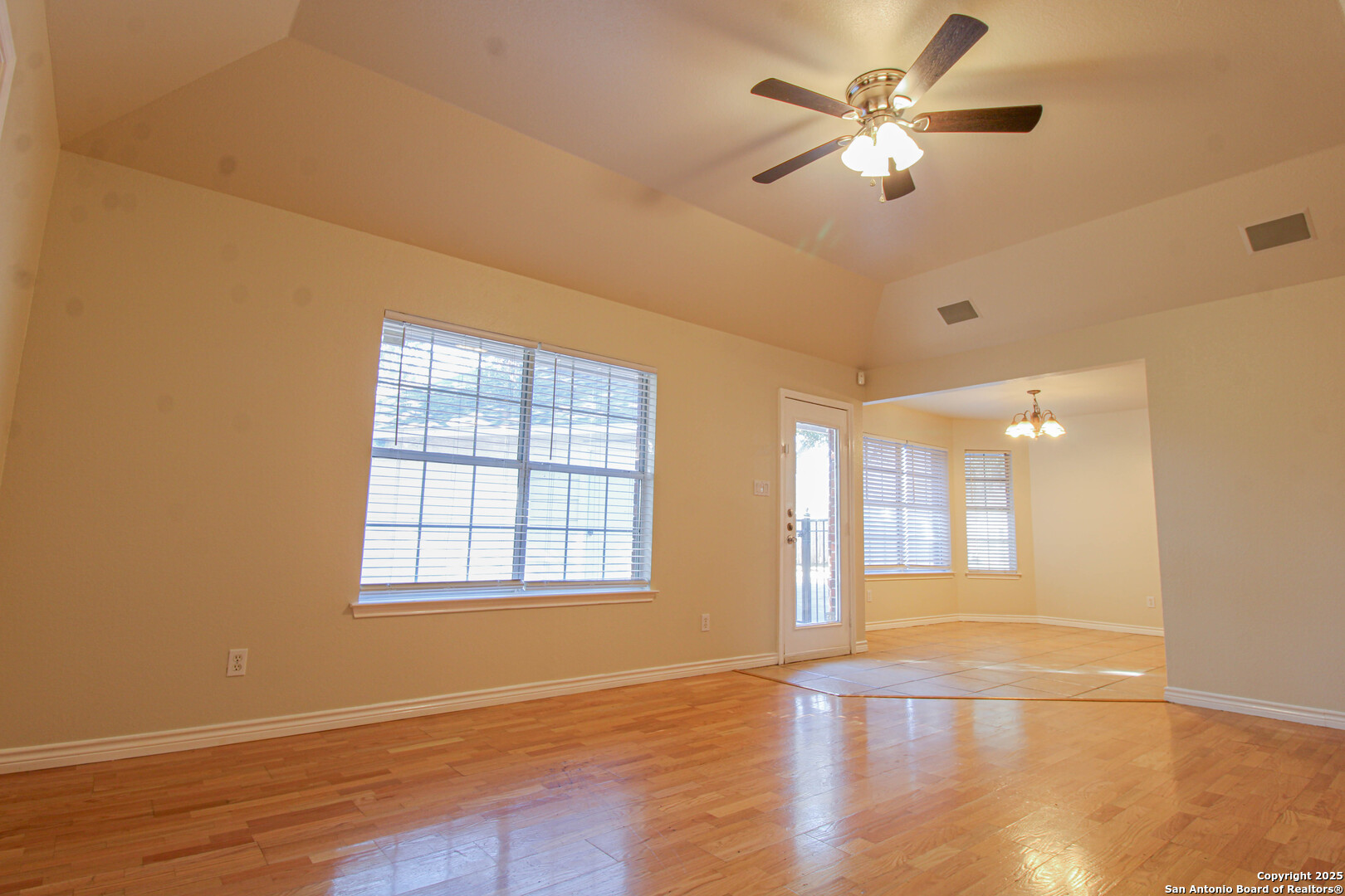 6703 Ridge Pl Street San Antonio, TX 78250 - Photo 10 of 44 a view of an empty room with a window and wooden floor