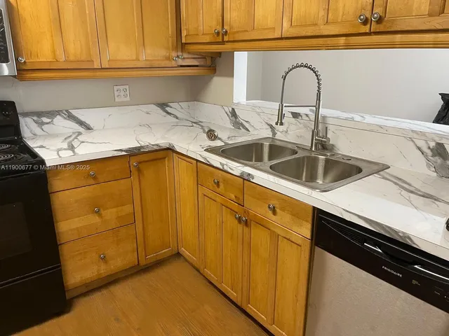 a kitchen with a sink and cabinets