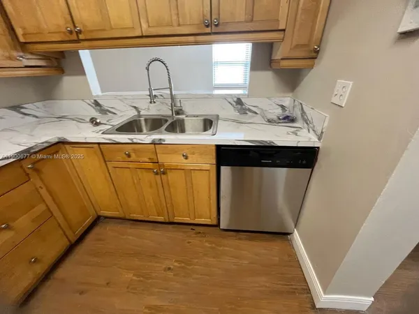 a kitchen with a sink and cabinets