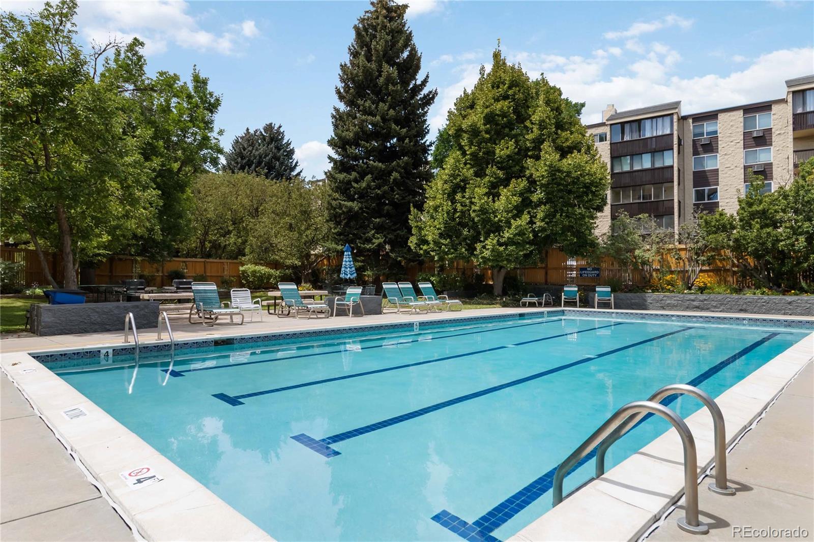 7040 East Girard Avenue, Unit E406 Denver, CO 80224 - Photo 27 of 27 a view of a swimming pool with a patio
