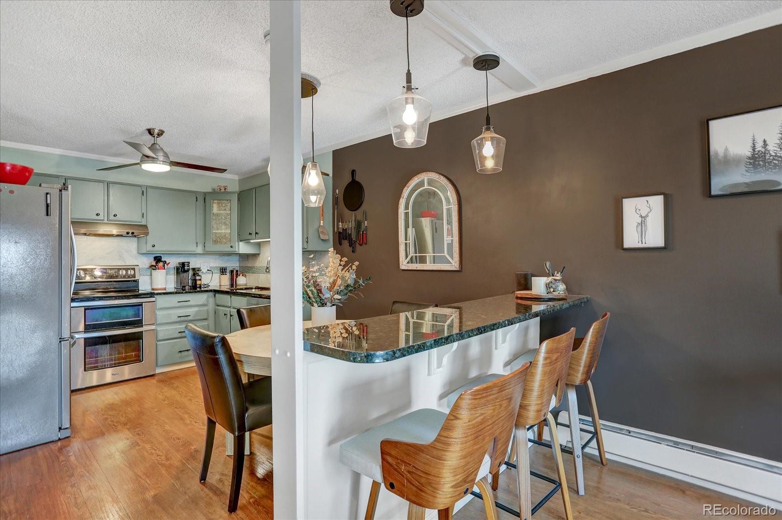7040 East Girard Avenue, Unit E406 Denver, CO 80224 - Photo 4 of 27 a view of a dining room with furniture